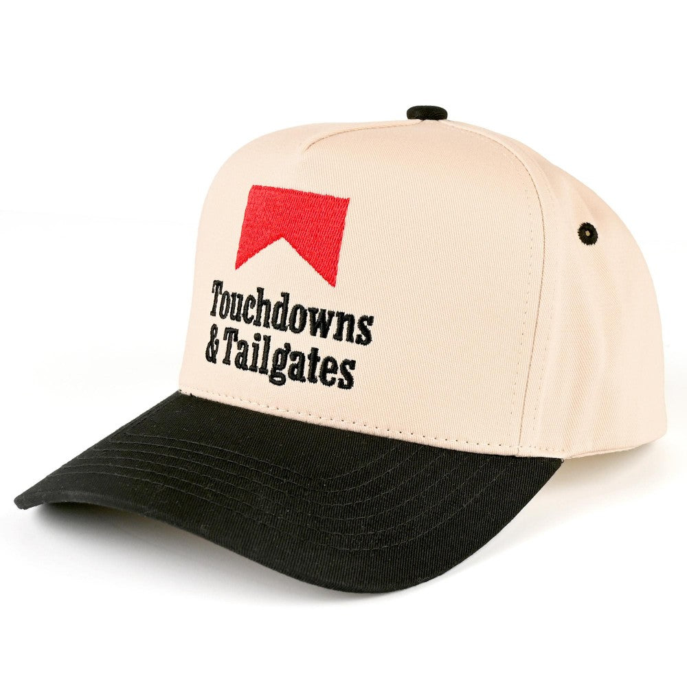 A beige and black baseball cap with a red logo and the embroidered text 'Touchdowns & Tailgates' on the front, shown on a clean white background.