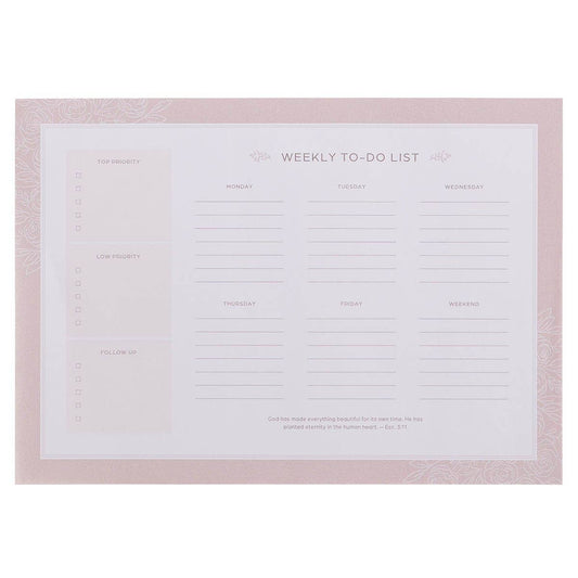 A weekly to-do list planner pad with a light pink border and a white center page featuring sections for tasks, priorities, and daily planning.