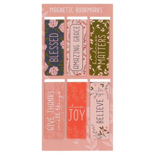 A set of six magnetic bookmarks displayed on a pink backing card. The bookmarks feature various floral and minimalist patterns with inspirational quotes including 'BLESSED', 'AMAZING GRACE', 'MATTERS', 'GIVE THANKS in all things', 'choose JOY', and 'BELIEVE'.