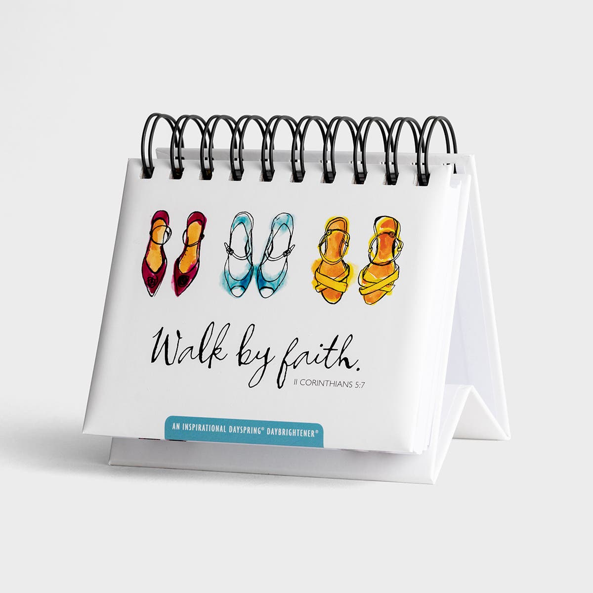 Small desk calendar with colorful sandals illustration and 'Walk by faith' text on a white background