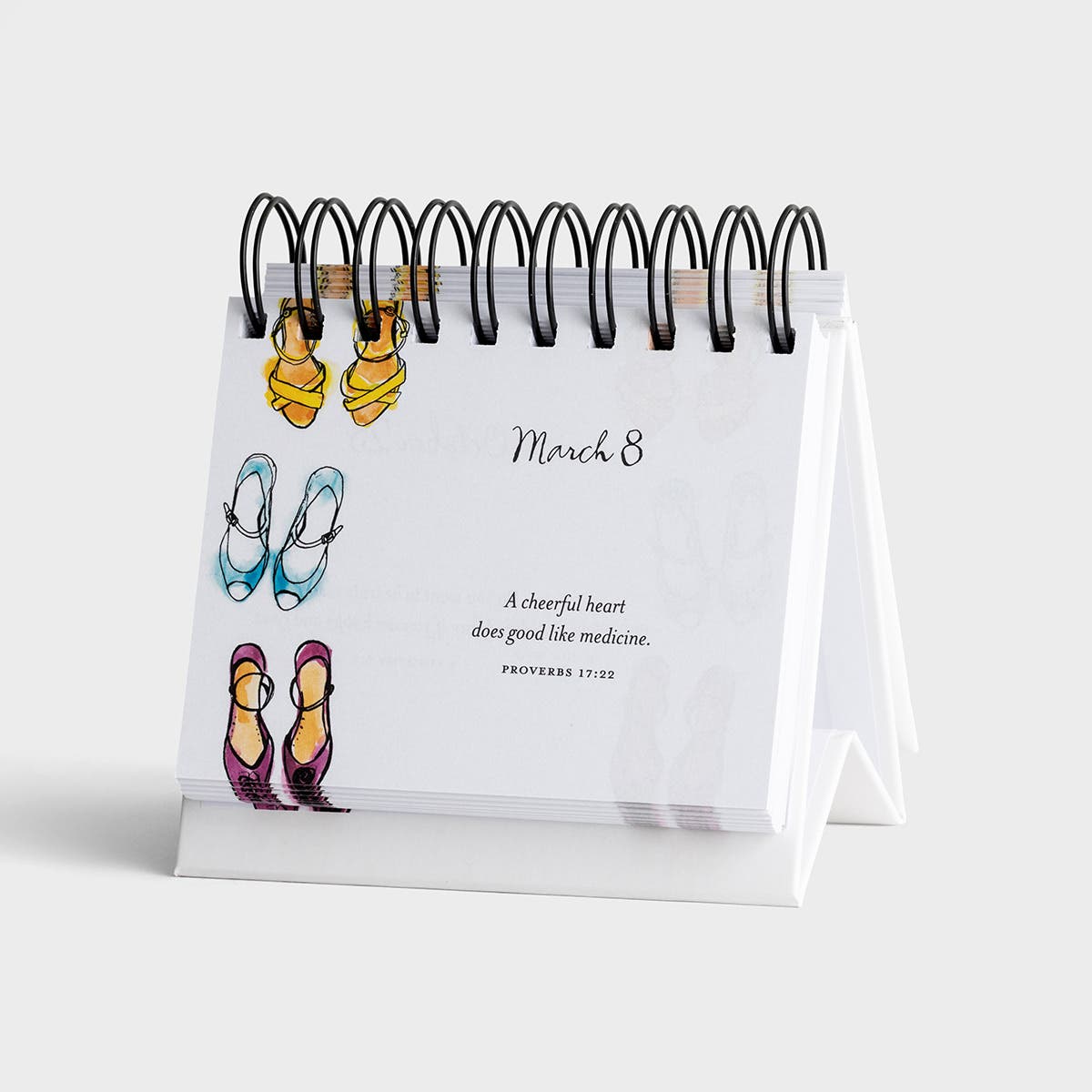 Small desk calendar with illustrations of shoes on a white background