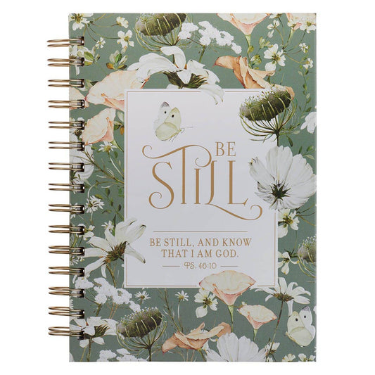 Journal with floral design and 'Be Still' text on a green background