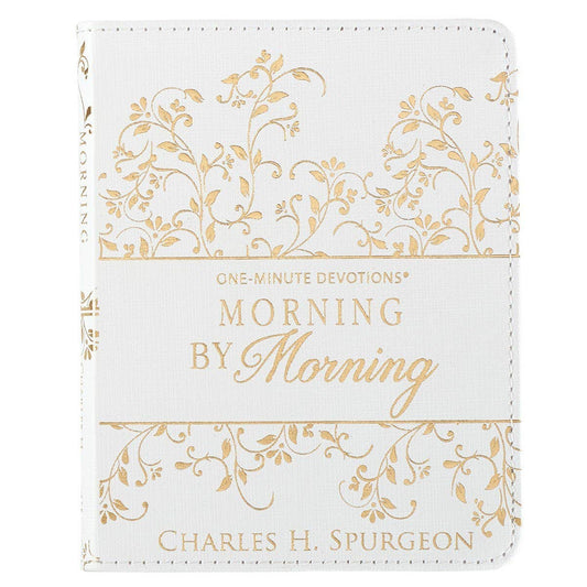 White book with gold floral patterns and text on a white background